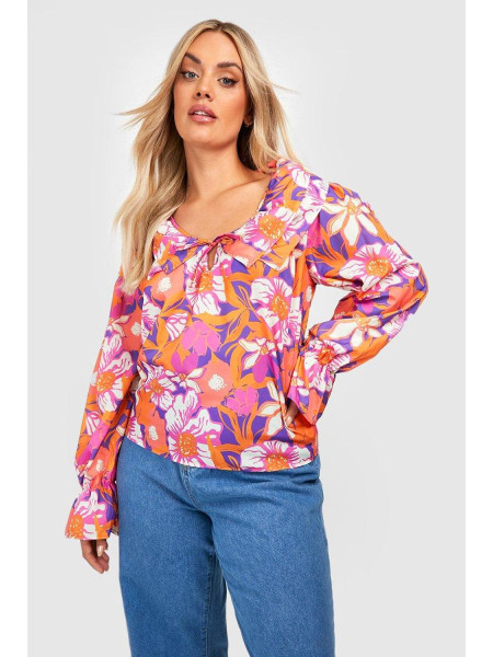 Помаранчева блузка з квітковими рюшами