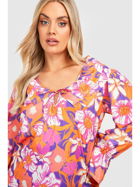 Помаранчева блузка з квітковими рюшами